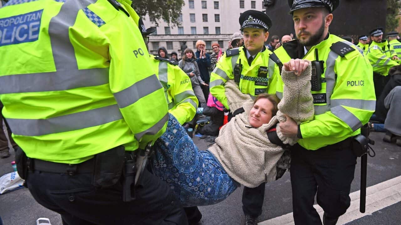 Police remove a protester from the Extinction Rebellion protest in London.