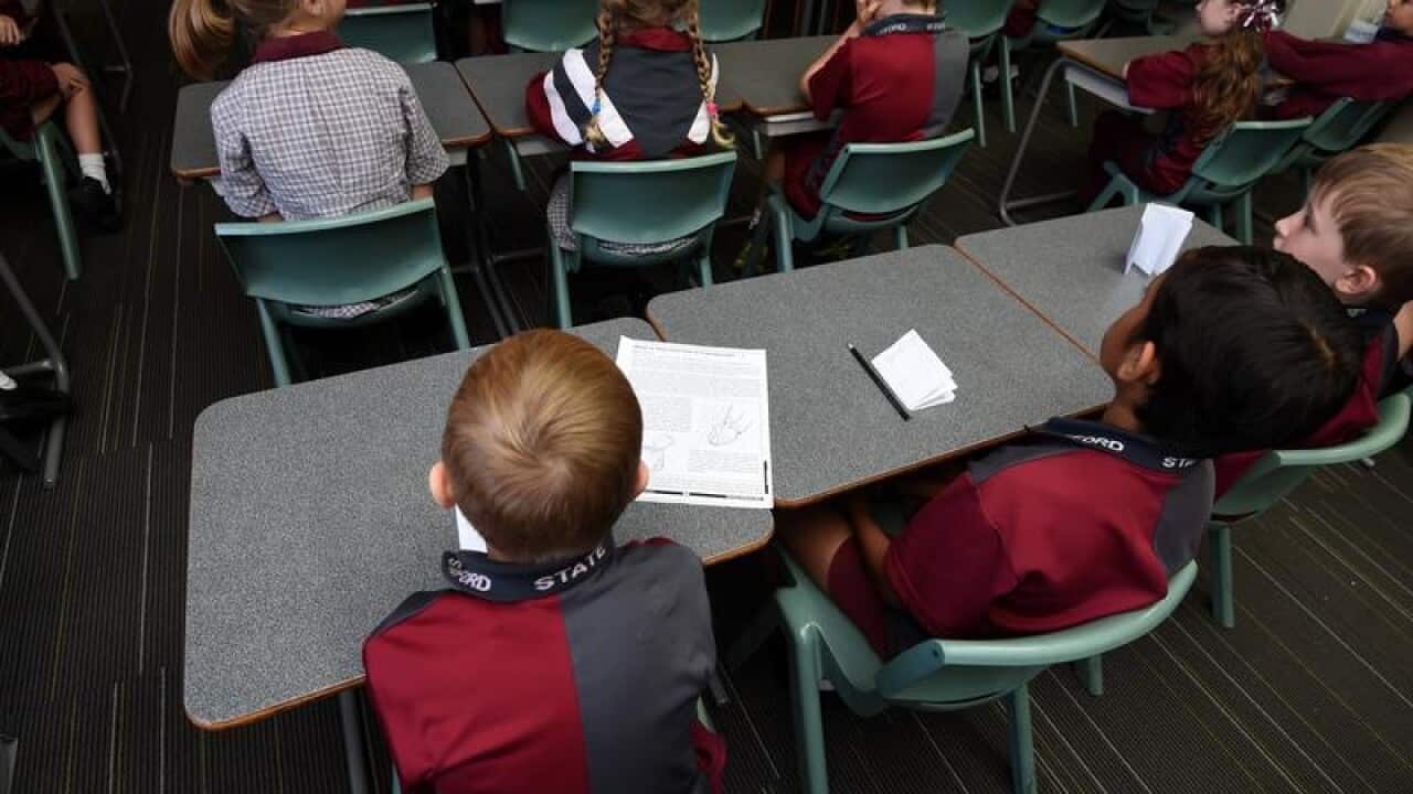 Children sit in a classroom