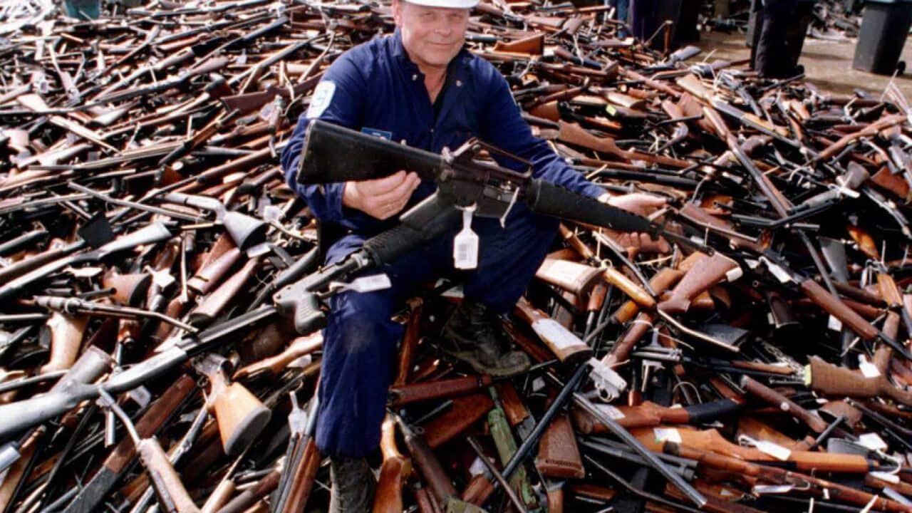 A security official holds an armalite rifle similar to the one used in the Port Arthur massacre, handed in for scrap in the gun amnesty