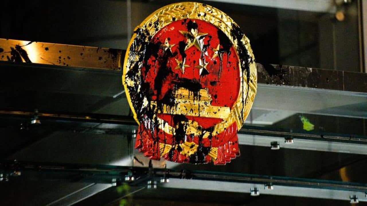 The Chinese national emblem at Hong Kong's China Liaison Office is splashed with paint by anti-extradition bill protesters