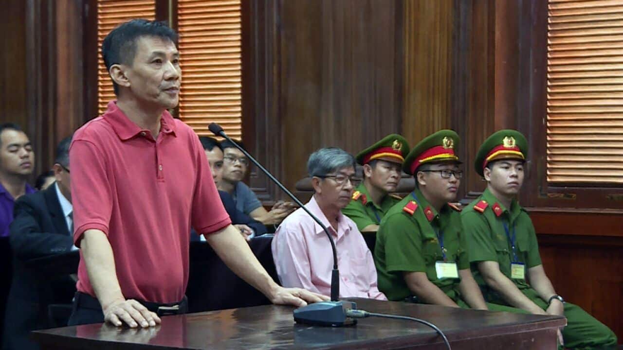 US citizen Michael Nguyen (L) standing on trial in Ho Chi Minh City