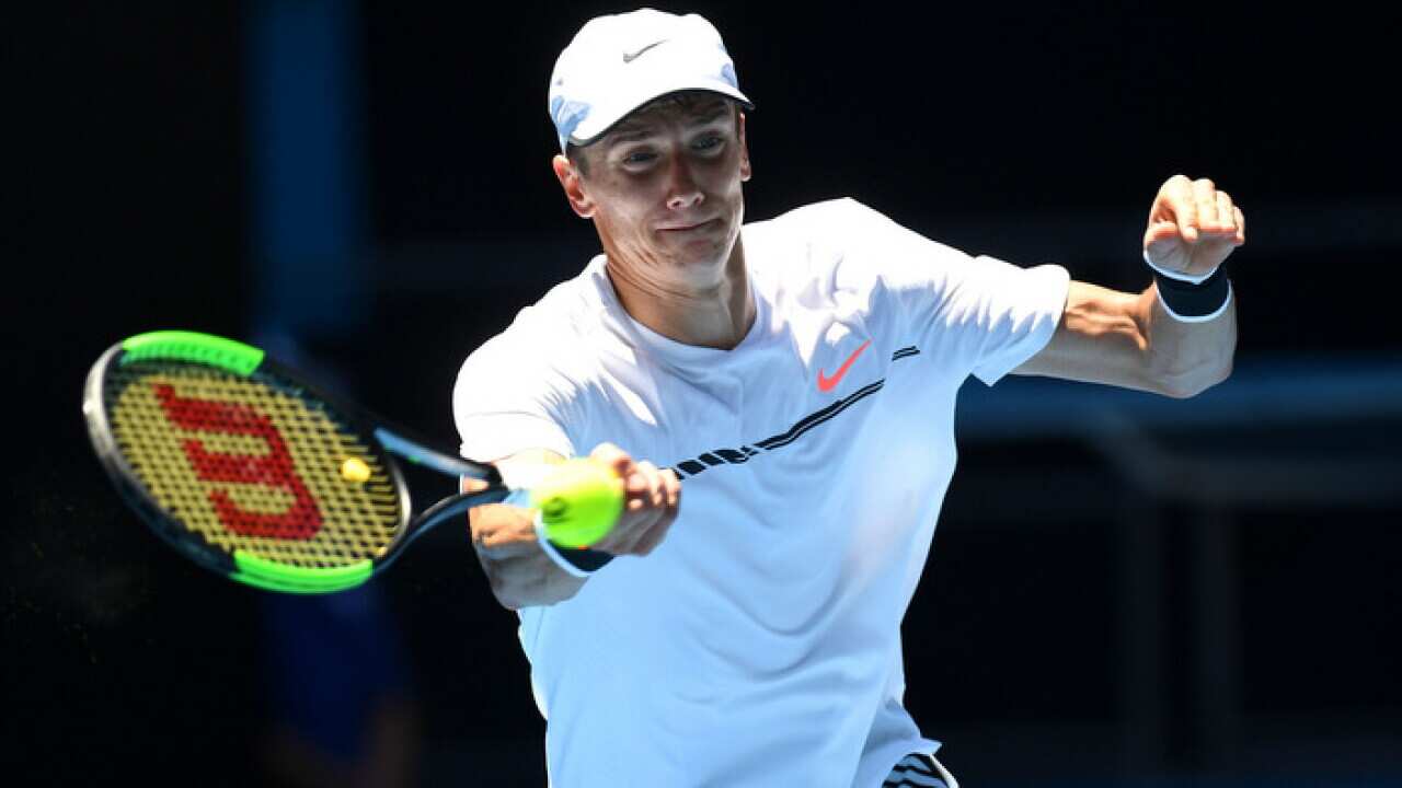 Andrey Kuznetsov of Russia plays a shot against Kei Nishikori of Japan the Round 1 of the Mens Singles at the Australian Open, in Melbourne, Australia Monday, Jan. 16, 2017. (AAP Image/Dean Lewins) NO ARCHIVING, EDITORIAL USE ONLY