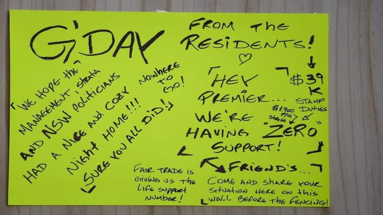 Residents sign at the evacuated Mascot Towers building.
