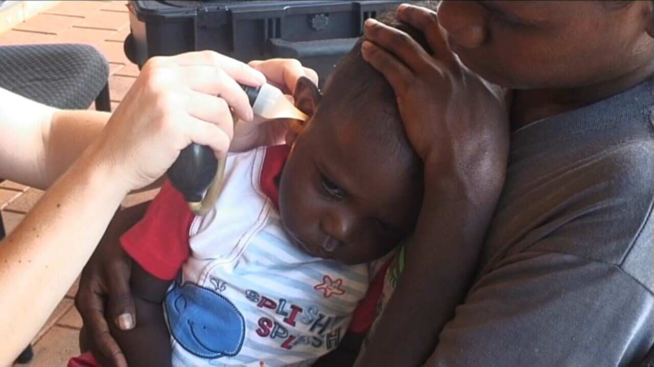 A child being examined for an ear infection