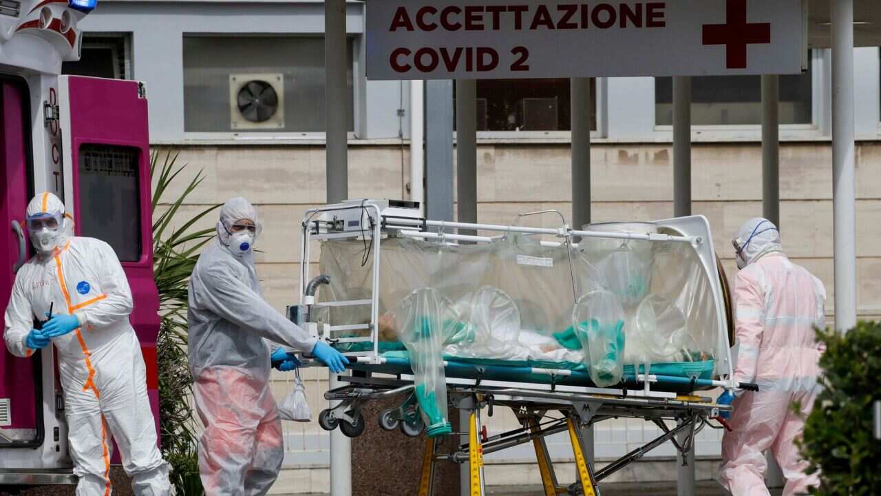 A patient in a biocontainment unit is carried on a stretcher from an ambulance arrived at the Columbus Covid 2 Hospital in Rome, Tuesday, March 17, 2020.