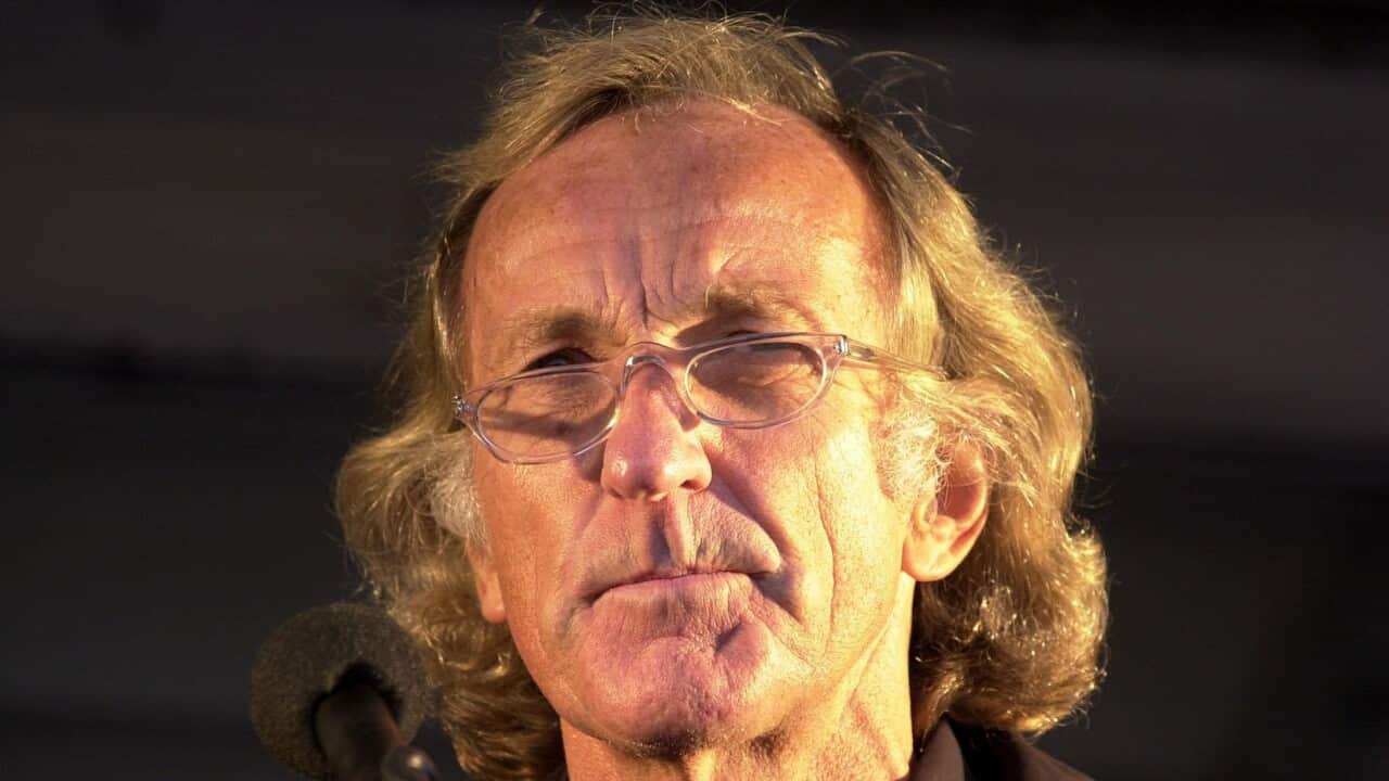 A man in glasses and black shirt.