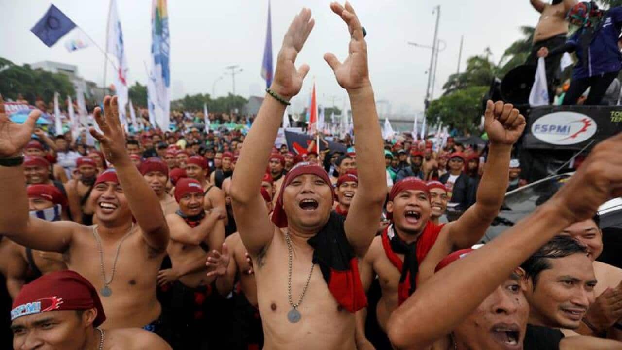Workers protest President Joko Widodo's proposed changes to Indonesia's labor laws outside the parliament in Jakarta on Jan. 20.