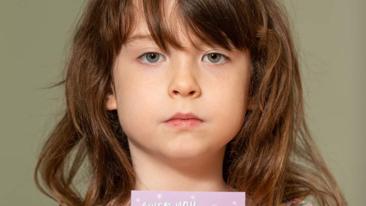 Florence Widdicombe holding a Tesco Christmas card from the same pack as the one which contained a message from a Chinese prisoner