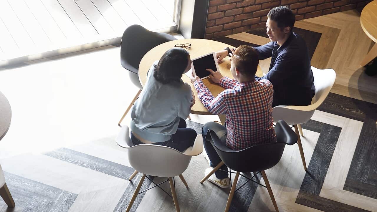 Overhead view of creatives working together in a co-working space.