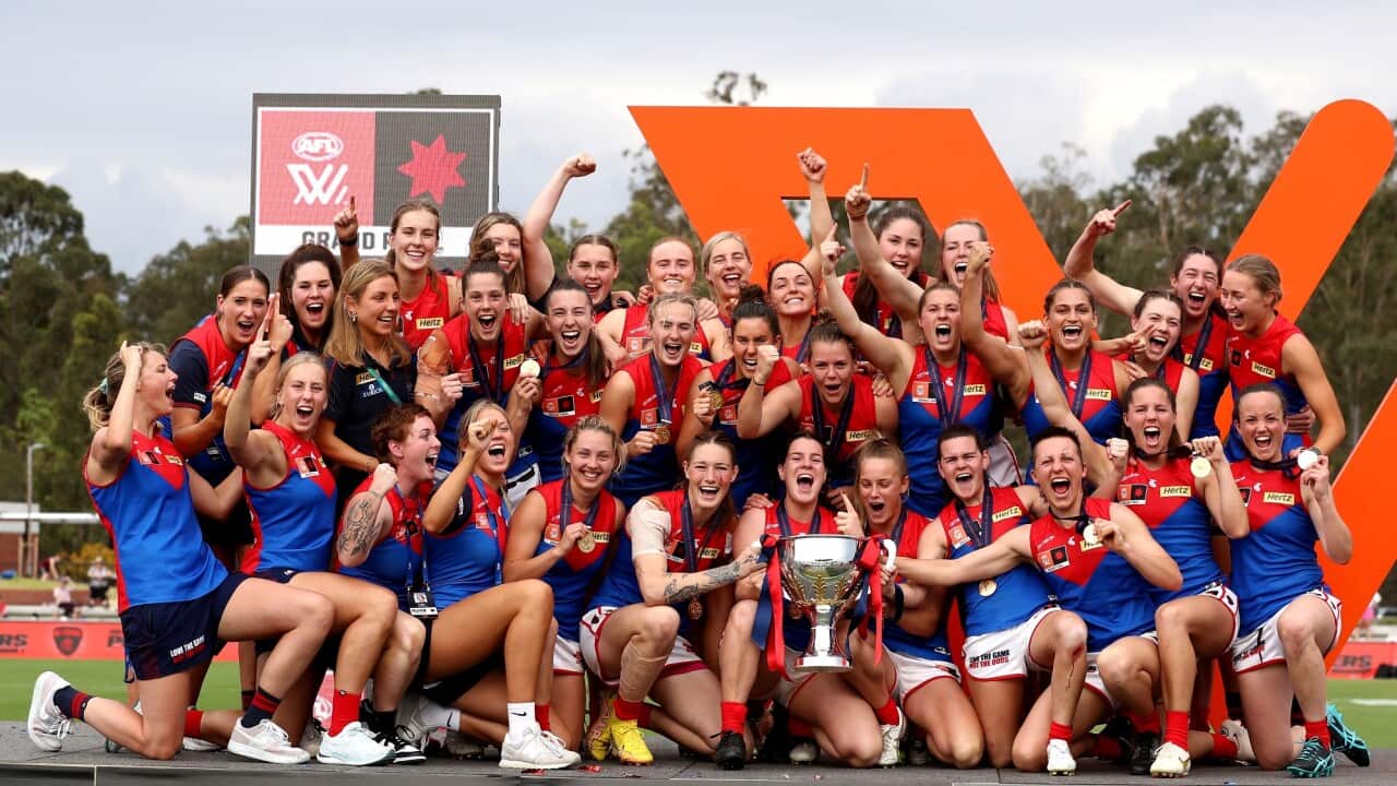 Demons players celebrate winning the premiership on 27 November 2022.