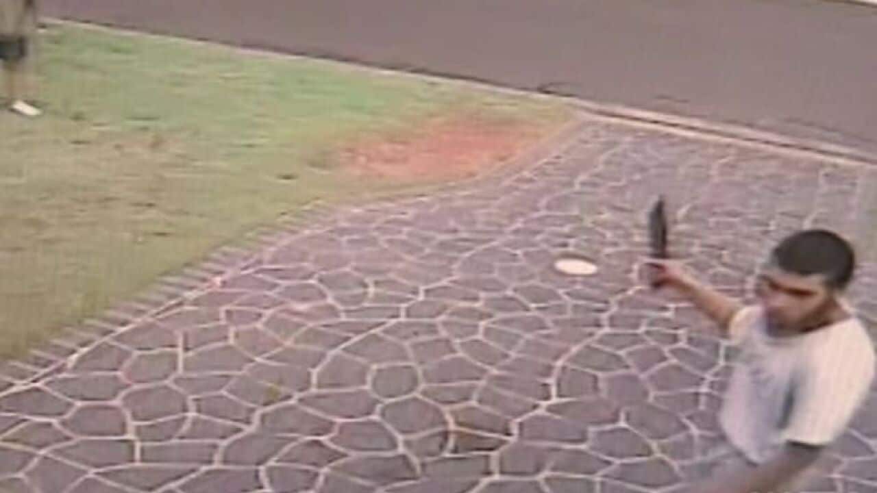 Ihsas Khan in Wayne Greenhalgh's driveaway, holding the knife used to stab him.