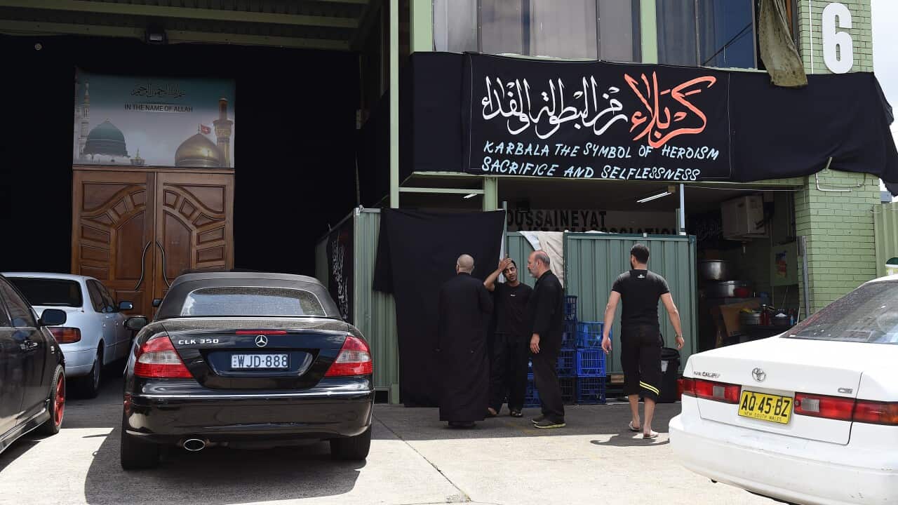 Members congregate outside a Shia Muslim prayer hall in Sydney, Nov. 3, 2014. A 47-year-old was sprayed with pellets outside the prayer hall. (AAP Image/Paul Miller)