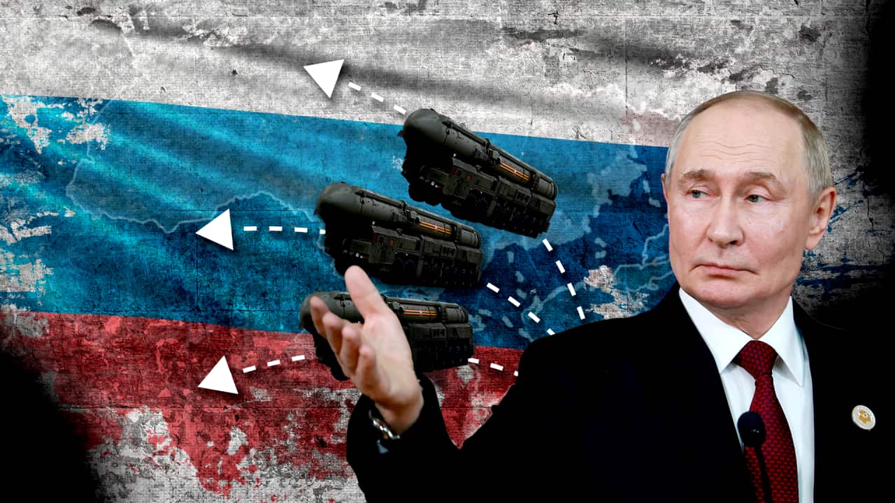 A man gestures with missiles and arrows behind him