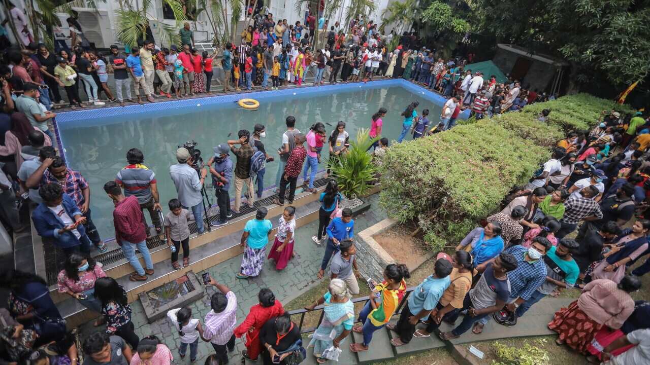People take a look at and a dip in a swimming pool at the President's palace in Colombo, Sri Lanka