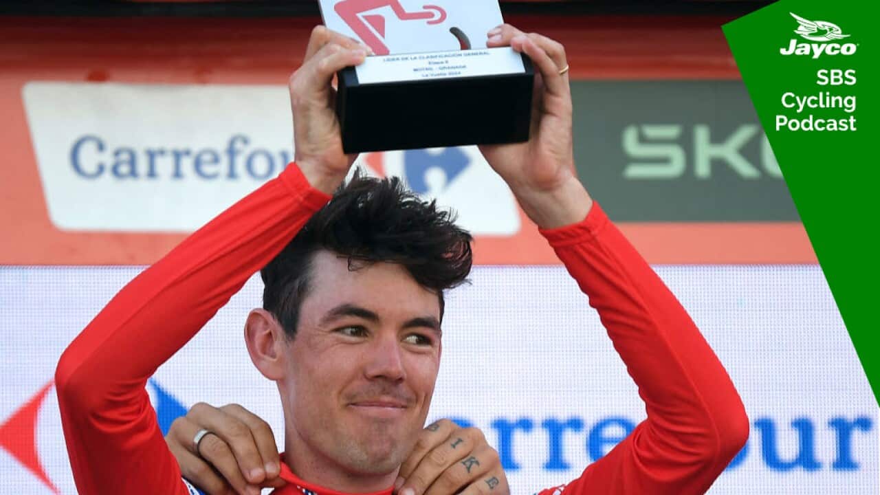 The overall ranking leader, Team Decathlon-AG2R La Mondiale's Ben O'Connor, celebrates on the podium retaining the red jersey after the stage 9 of the Vuelta a Espana, a 178,5 km race between Motril and Granada, on August 25, 2024. (Photo by Jorge GUERRERO / AFP)