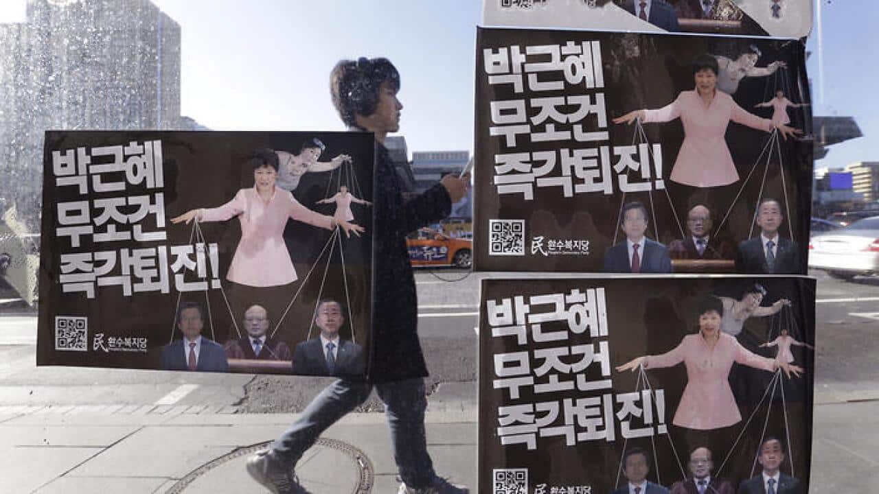 Posters depicting impeached South Korea's President Park Geun-hye manipulating her aides while she is also a marionette by her jailed confidante Choi Soon-sil.