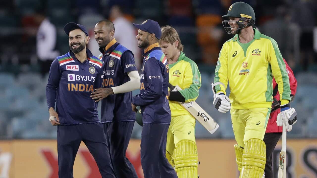 India's Virat Kohli, left, celebrates with teammates after defeating Australia in their one day international cricket match at Manuka Oval in Canberra, Australia, Wednesday, Dec. 2, 2020. India won the match by 13 runs. (AP Photo/Mark Baker)