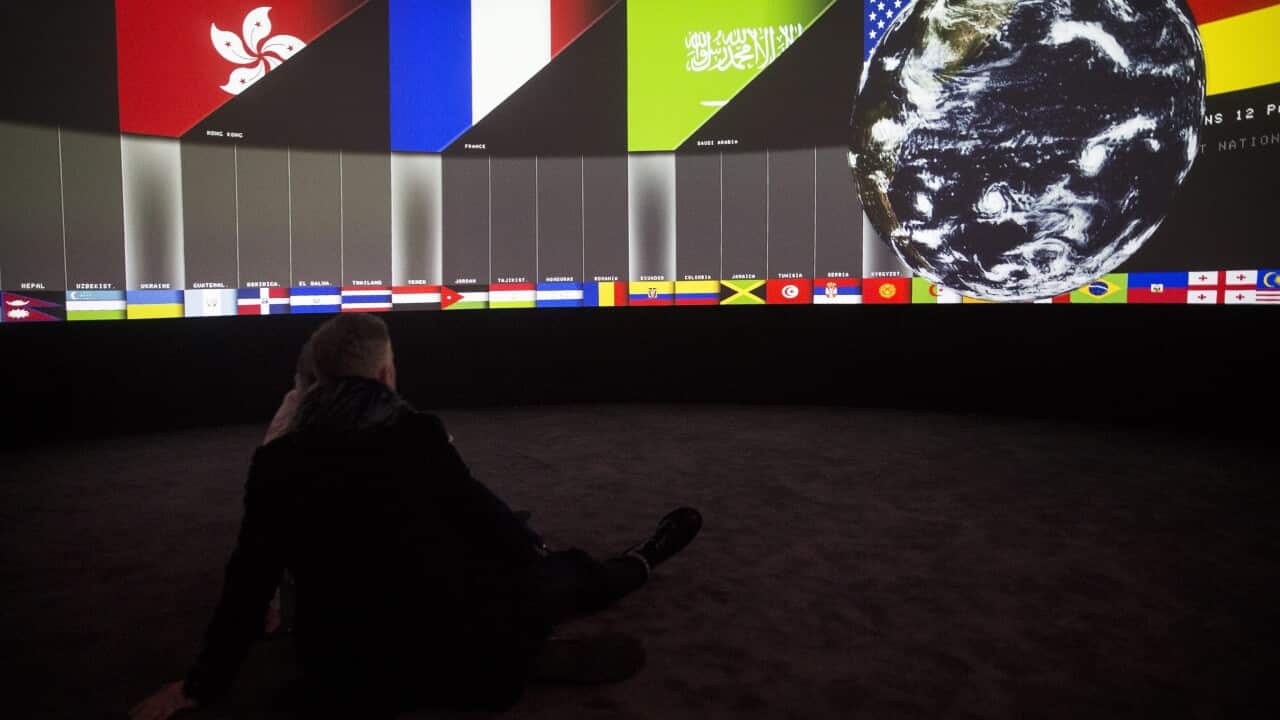A visitor watches the projection of the installation 'EXIT' by the artists and architects Diller Scofidio and Renfro at the Grand Palais in Paris