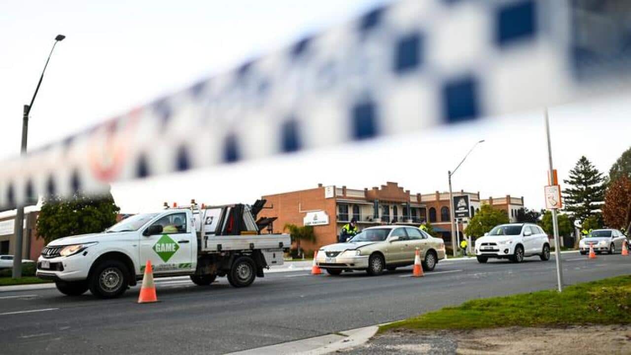 NSW Police officers check cars crossing from Victoria at a border check point in the border town of Albury.