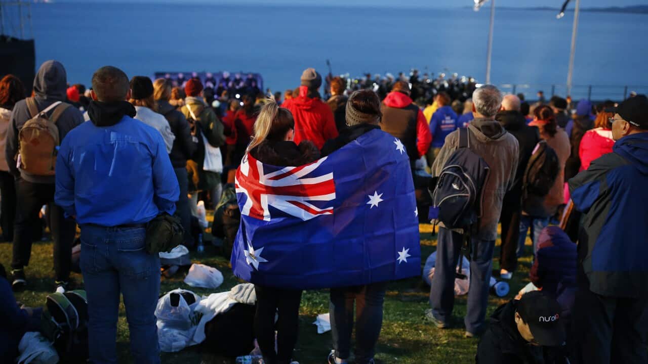 A pair draped with an Australian flag, participate in the Dawn Service ceremony at the Anzac Cove beach in Gallipoli, Turkey.