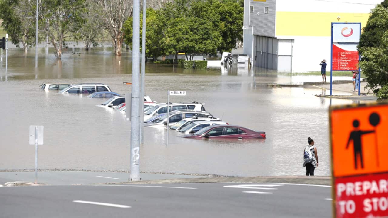 Vehicles submerged in flood water near Beenleigh train station