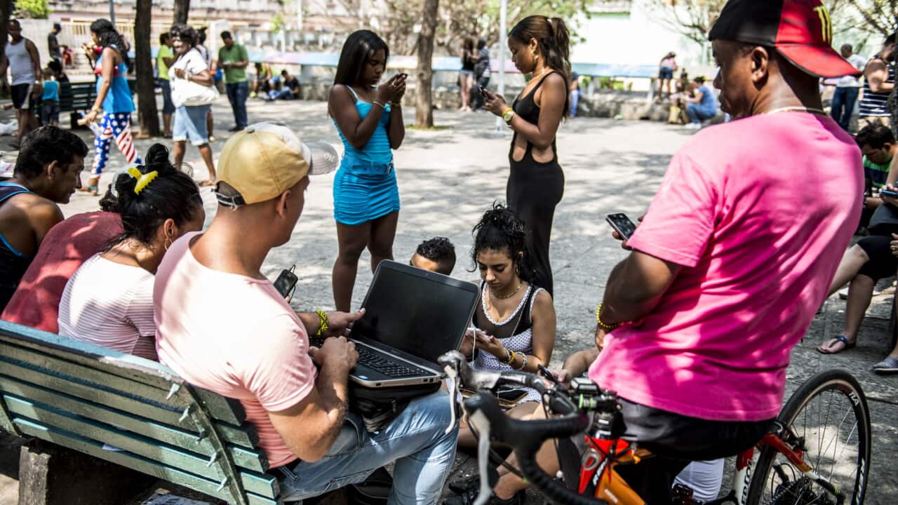 A group of young Cubans enjoy WiFi internet
