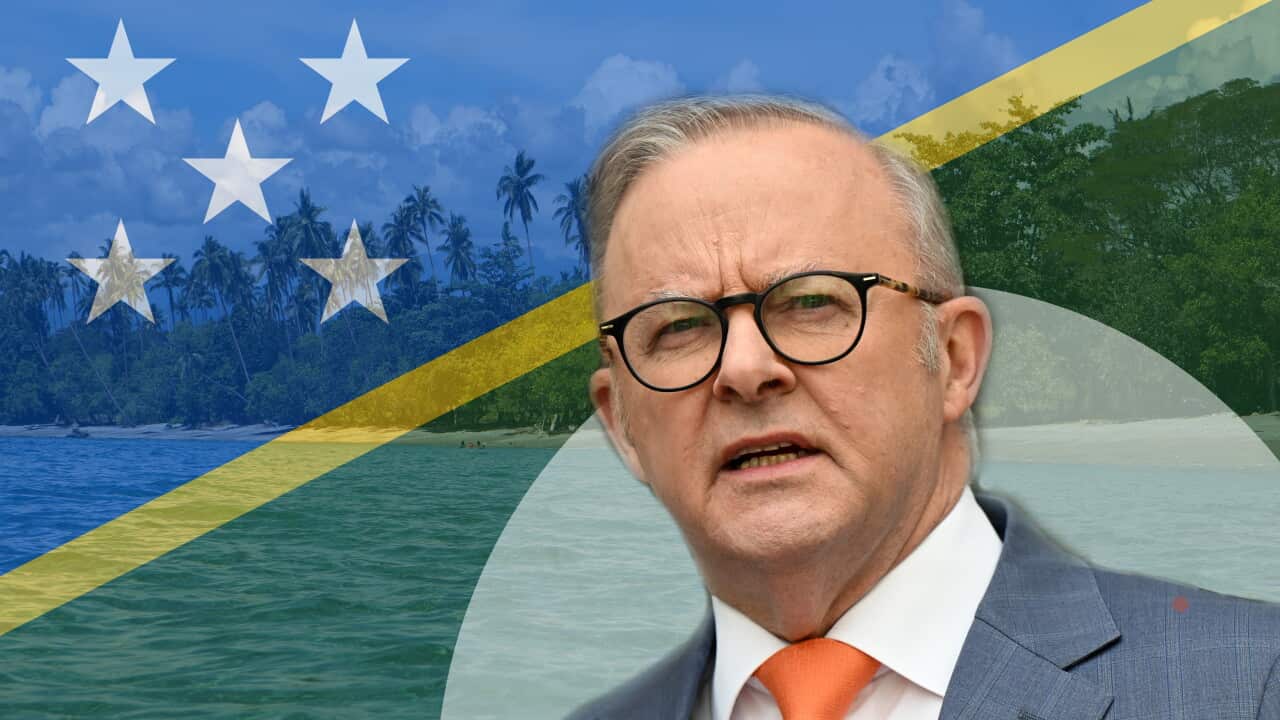 Anthony Albanese pictured against the Solomon Islands flag