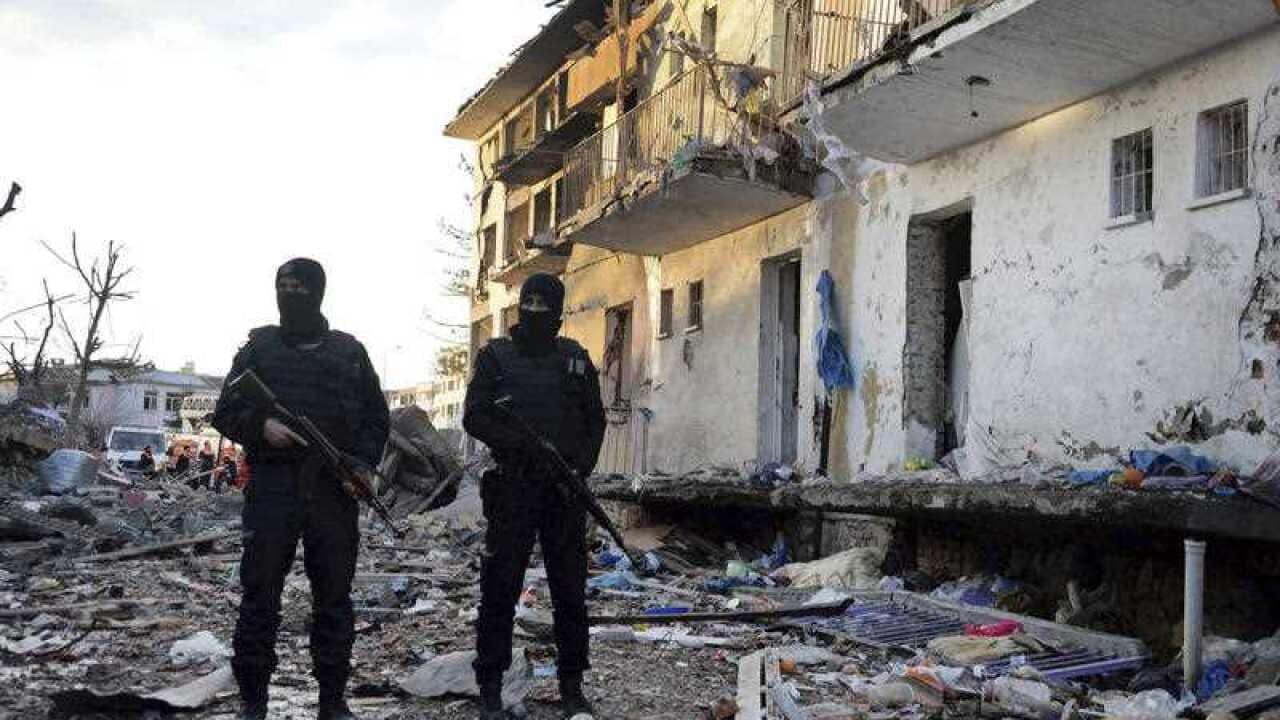 Turkish police officers secure a destroyed police station in Cinar in the mostly-Kurdish Diyarbakir province in southeastern Turkey.