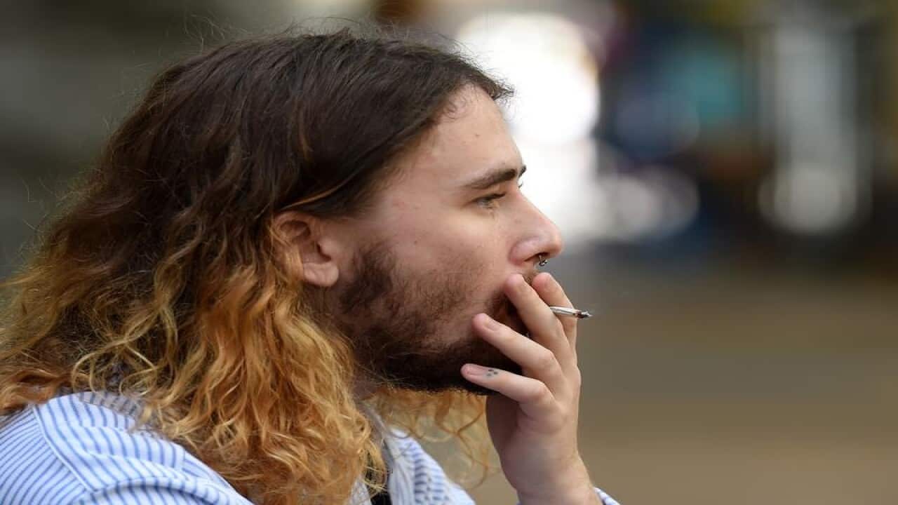 A man smokes during lunchtime in central Brisbane.