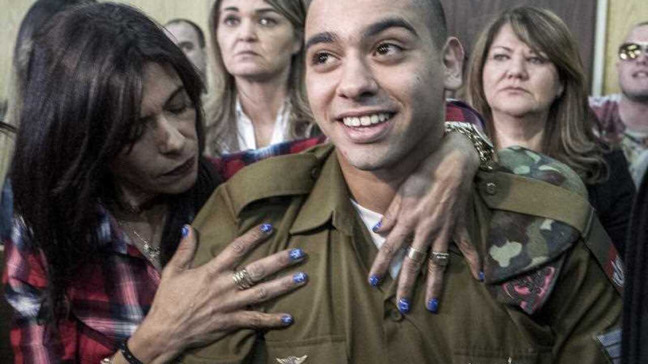 Israeli soldier Elor Azaria is embraced by his mother at the start of his sentencing hearing in Tel Aviv, Israel, Tuesday, Feb. 21, 2017.