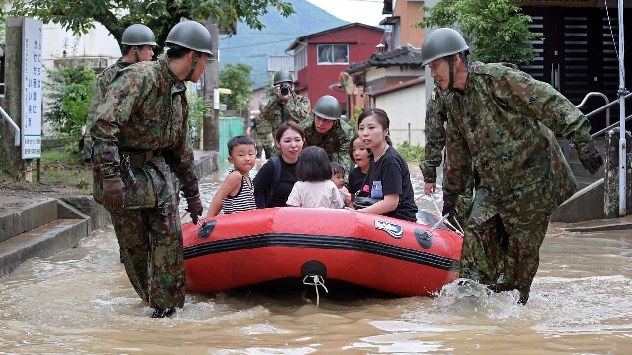 People are rescued by Japan Self-Defense Forces following floods in Takeo, Saga prefecture.