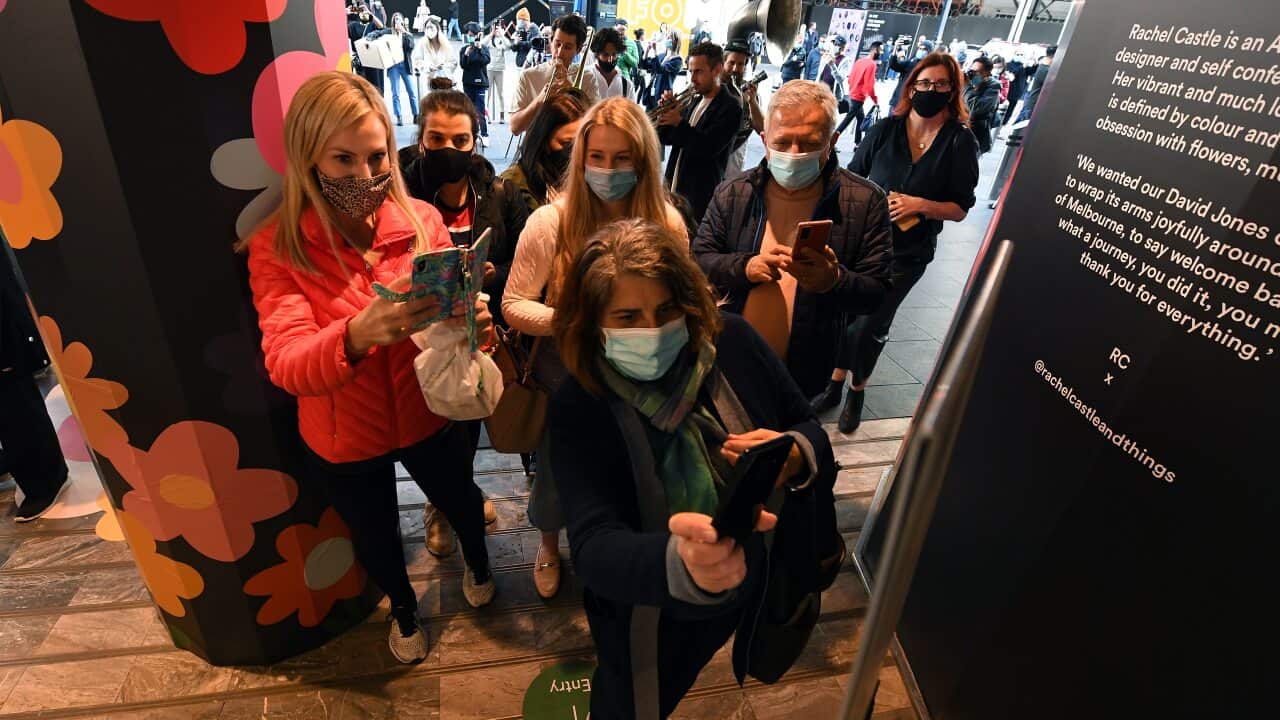 People use a QR code before entering the David Jones retail store in Melbourne, Friday, October 29, 2021. At 6pm, the border between Melbourne and the regions will come down, masks will no longer need to be worn outdoors, indoor entertainment venues, gyms