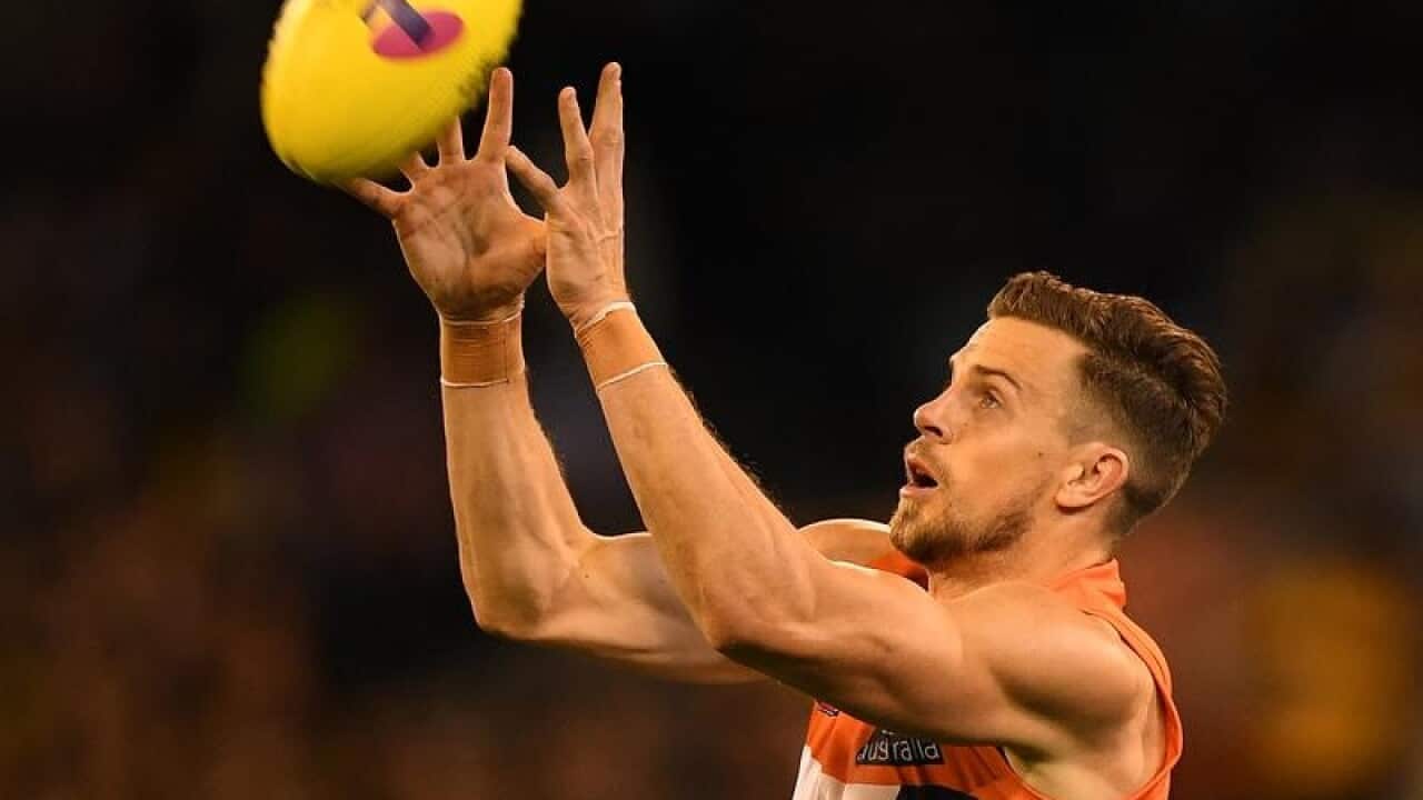 File image of Brett Deledio of the Giants catching the AFL ball.