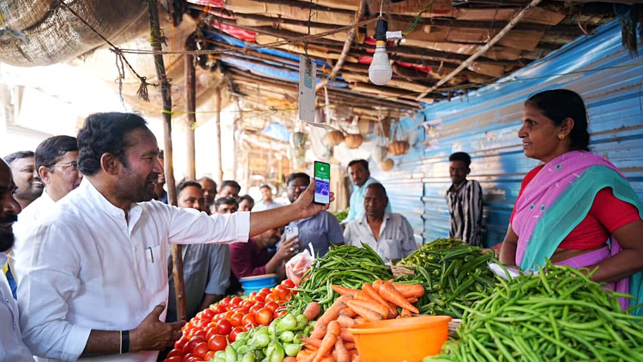 India: G. Kishan Reddy makes a payment through the UPI to a vegetable seller at a roadside market in Jubilee Hills