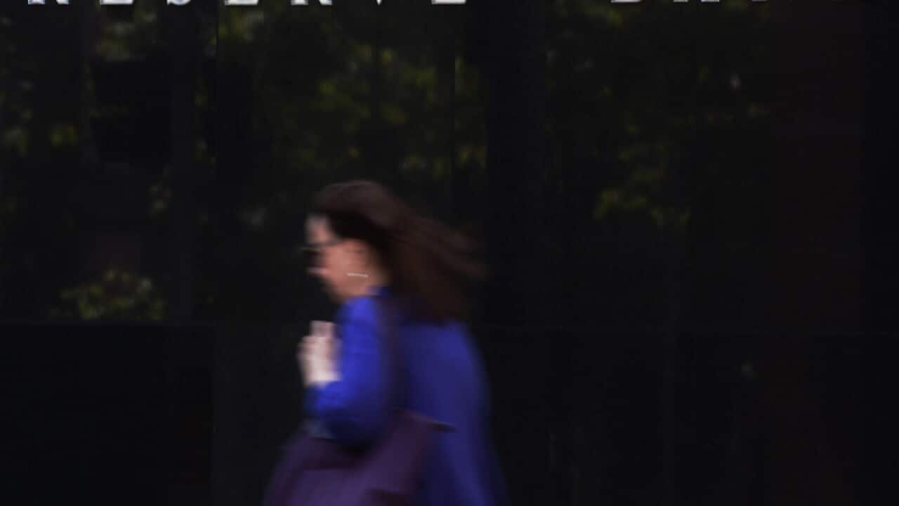 A pedestrian walks past the Reserve Bank of Australia building