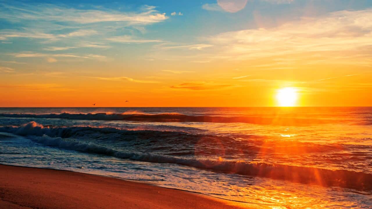 Vertical shot of the North Entrance Beach at sunrise under a blue sky