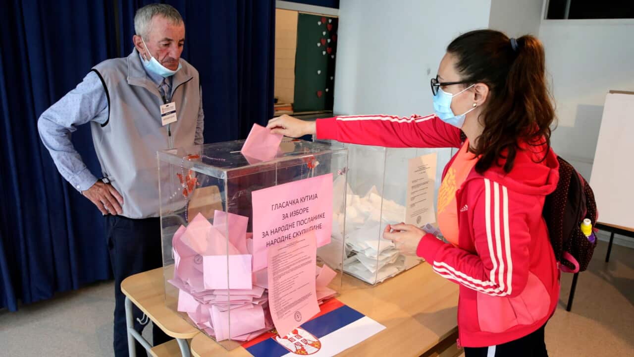 A woman wearing a protective face mask casts her ballot at a polling station in Belgrade, Serbia, 21 June 2020. The Western Balkan nation's voters are choosing their representatives in the 250-seat National Assembly. The balloting was originally scheduled