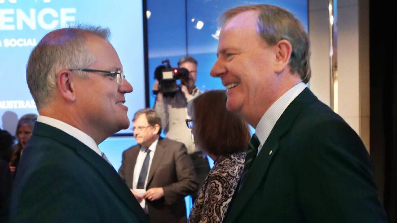 Former Australian Treasurer Peter Costello (left) speaks with Australian Prime Minister Scott Morrison at the Melbourne Institute Economic and Social Outlook Conference in Melbourne, Thursday, October 11, 2018. (AAP Image/David Crosling) NO ARCHIVING