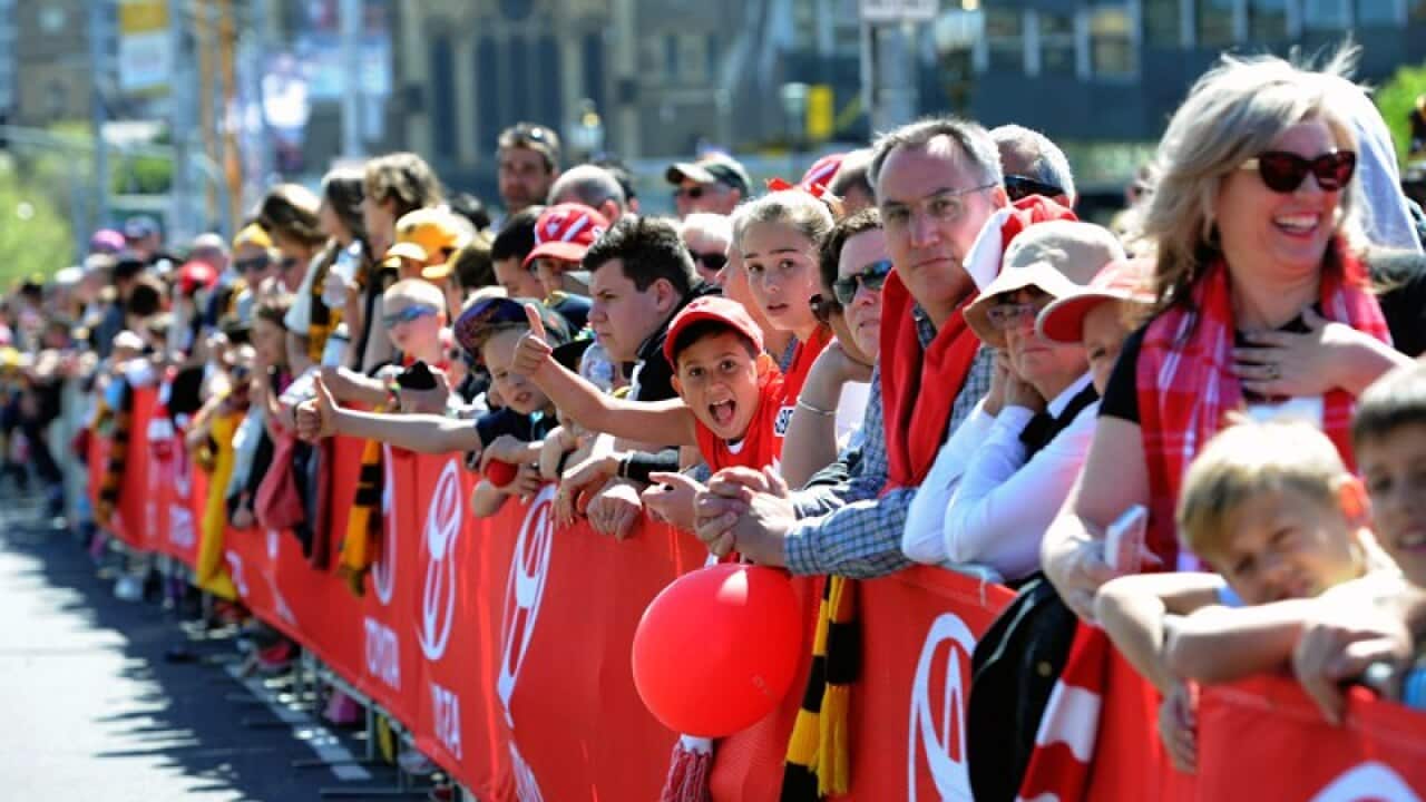 Swans and Hawks fans gather for the Grand Final parade in Melbourne