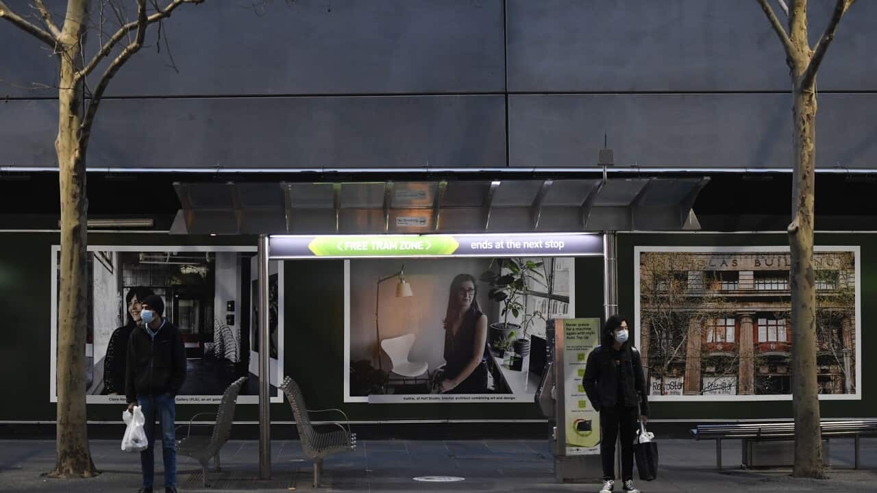 People wait for a tram in Melbourne on 2 August 2020.  