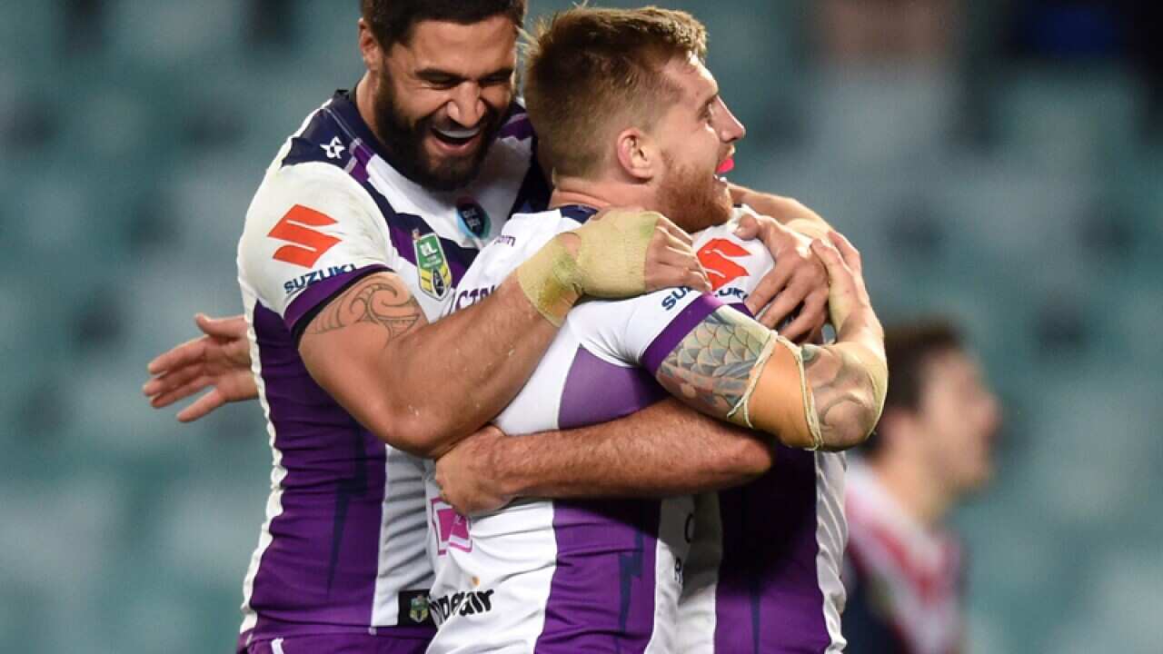 Cameron Munster (centre) of the Storm is congratulated