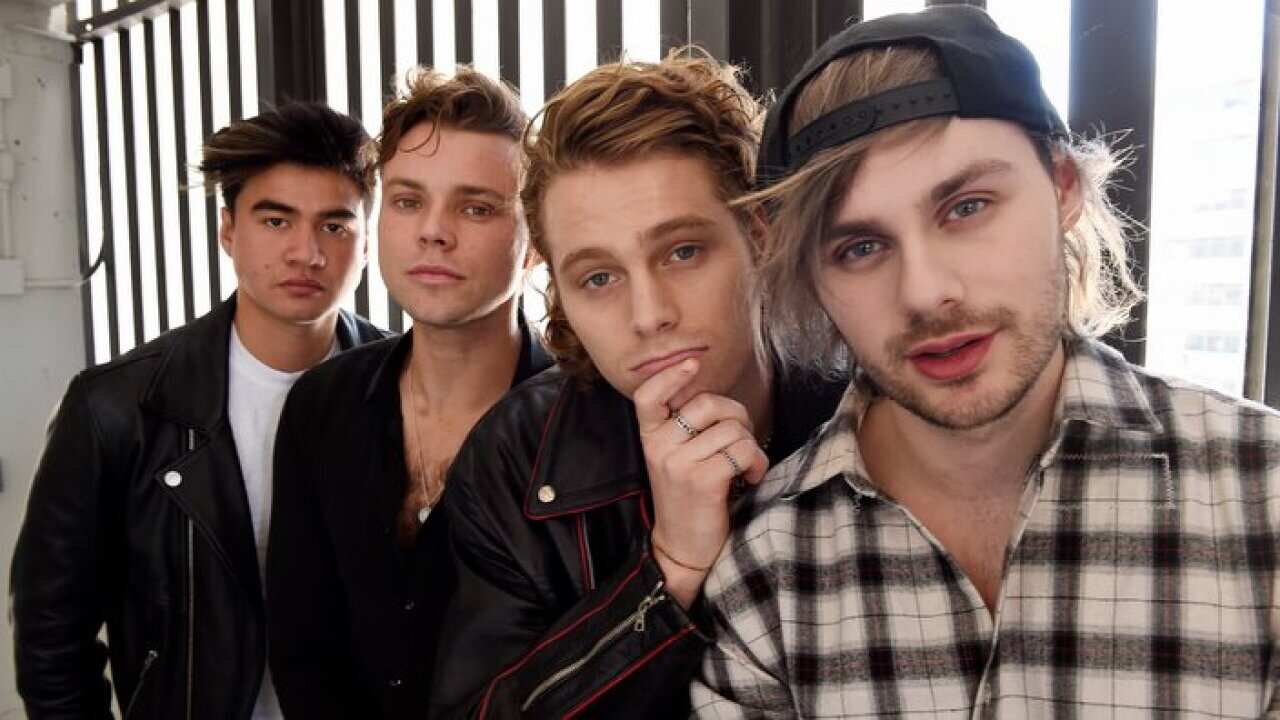 HOLD FOR STORY -- From left, Calum Hood, Ashton Irwin, Luke Hemmings and Michael Clifford of the band 5 Seconds of Summer pose together at Capitol Records, Thursday, Oct. 18, 2018, in Los Angeles. (Photo by Chris Pizzello/Invision/AP)
