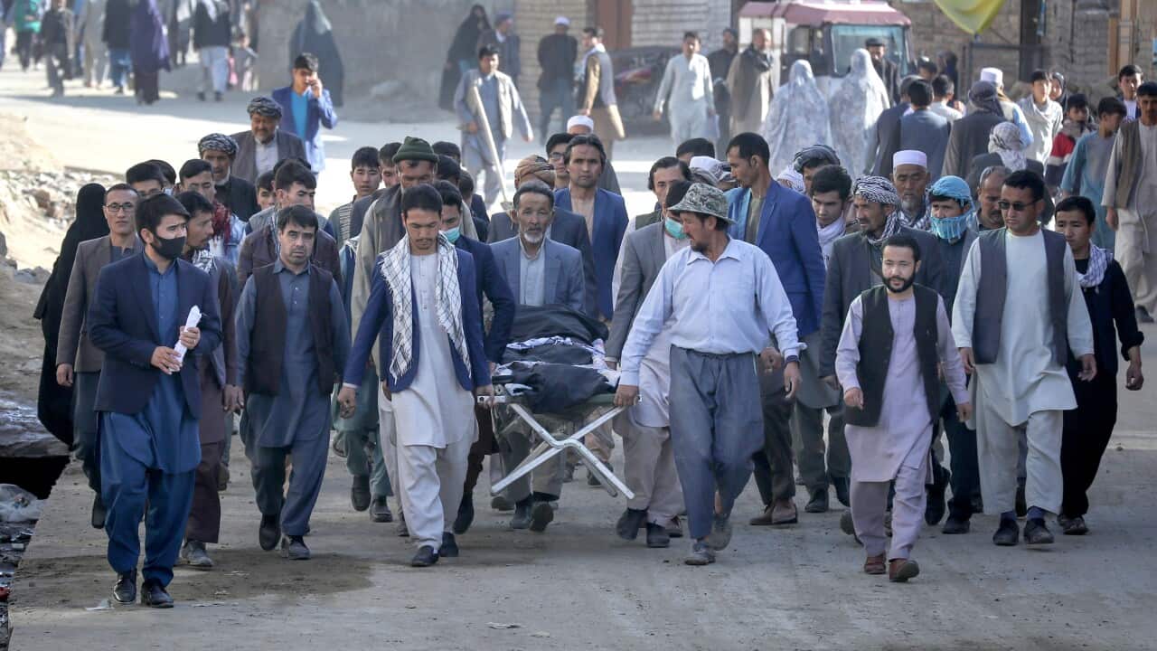 People attend the funeral of one of the victims of an attack that targeted a school in the west of Kabul, Afghanistan, 9 May 2021.