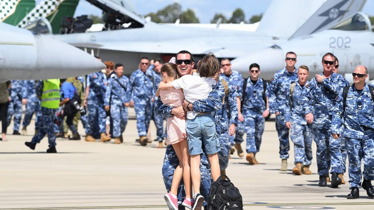 A returning officer is greeted by his children.