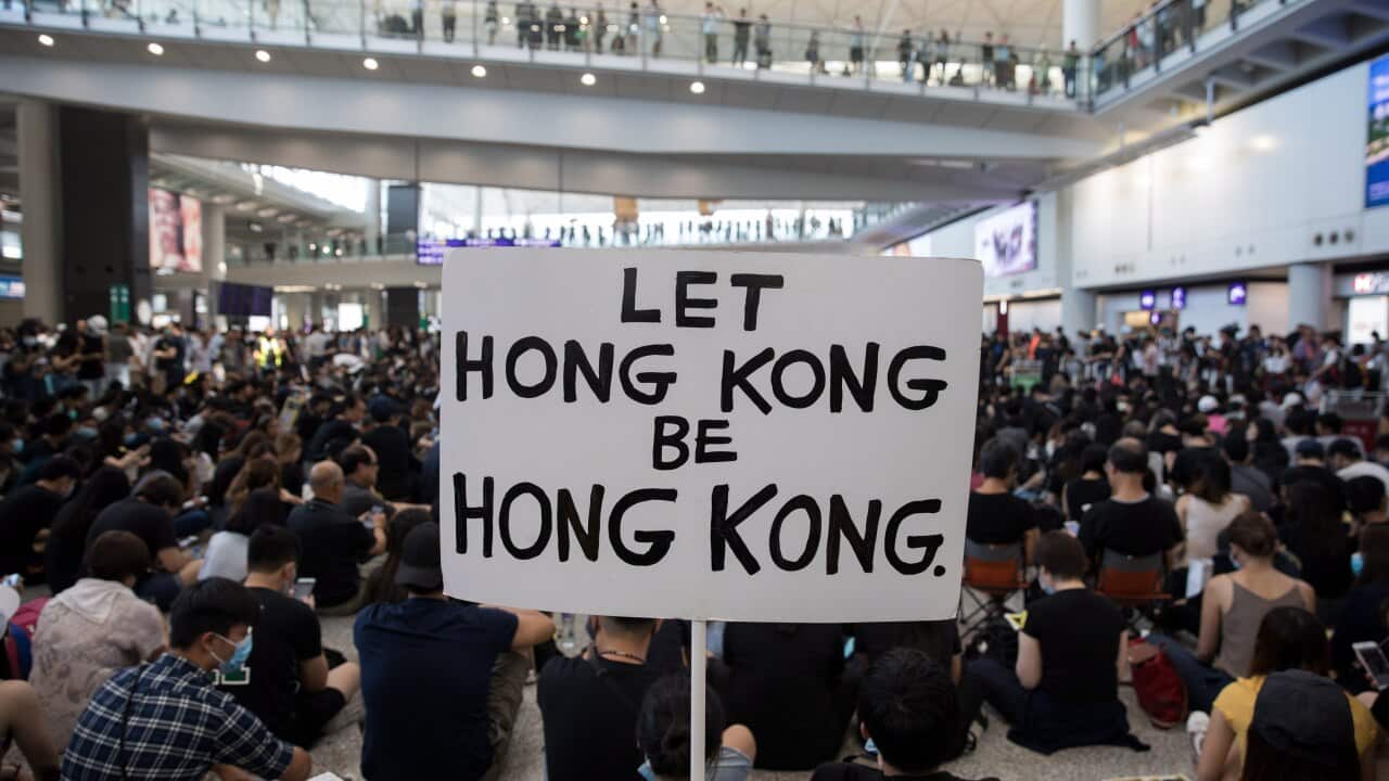 Protesters rally inside the arrivals hall of Hong Kong International Airport in Hong Kong.