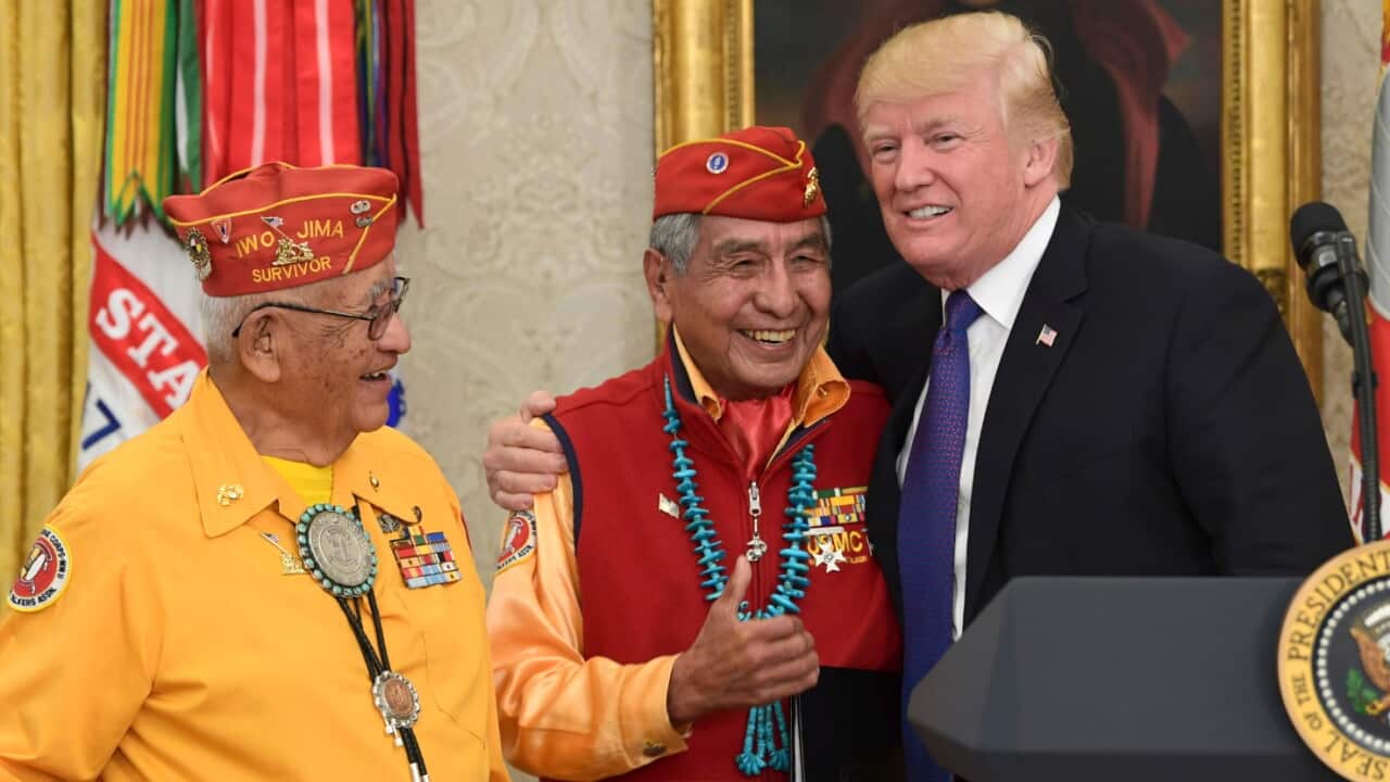 President Donald Trump, right, meets with Navajo Code Talkers Peter MacDonald, center, and Thomas Begay, left, in the Oval Office of the White House in Washington, Monday, Nov. 27, 2017.