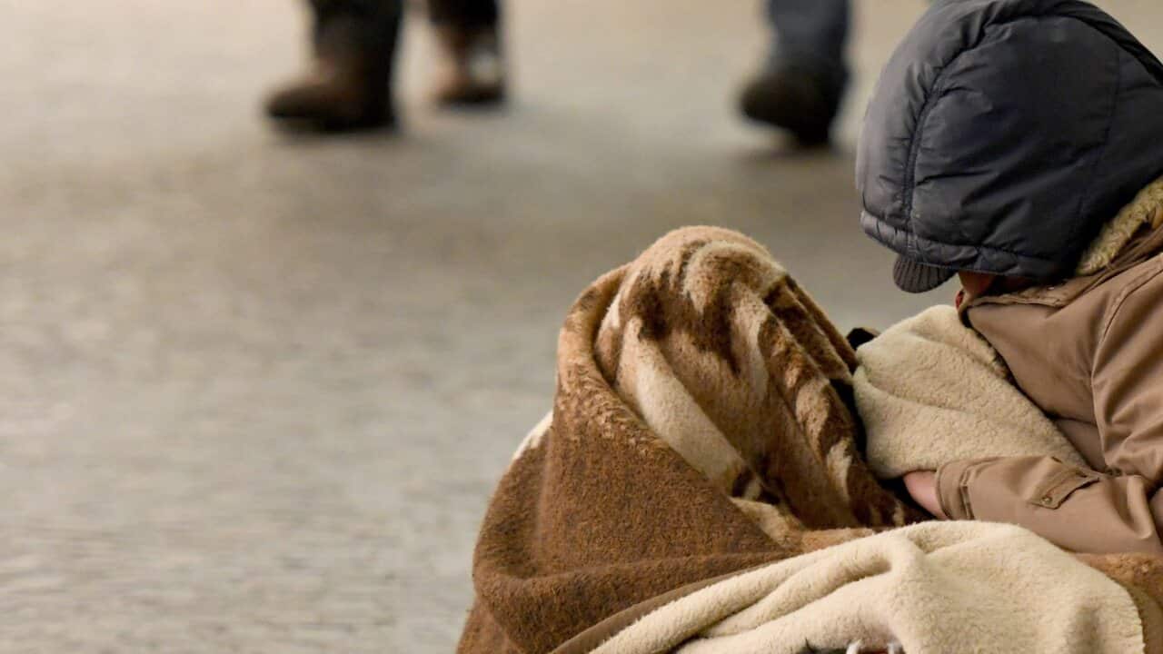 homeless man sleeping in the street, Freiburg, Feb. 14, 2018 | usage worldwide