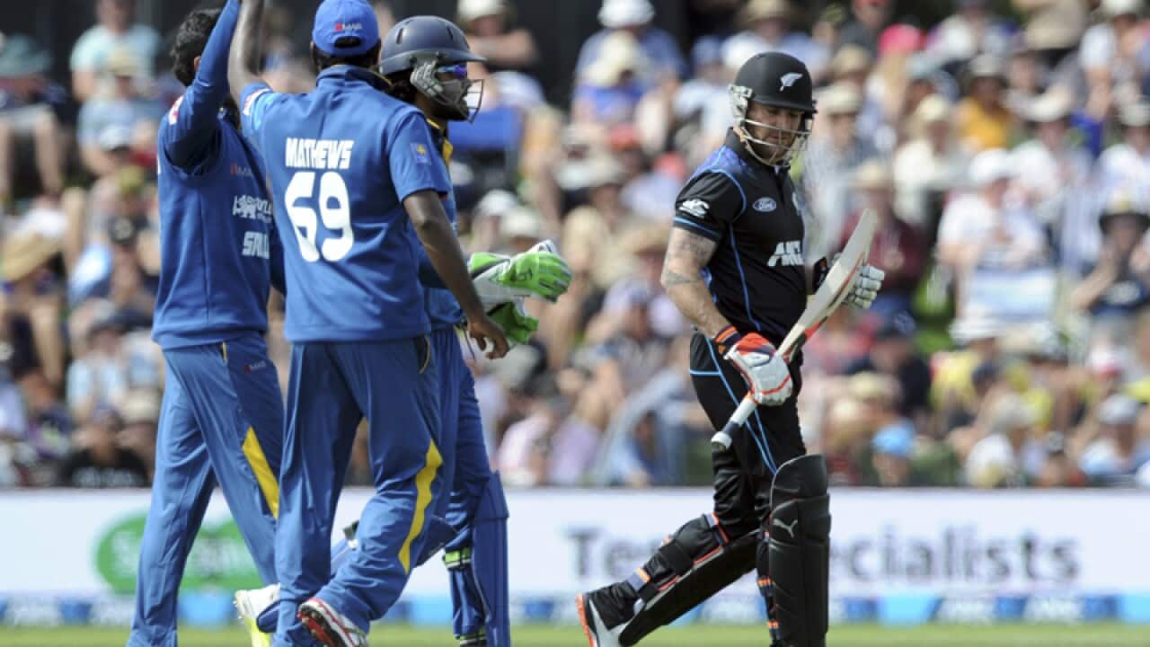 New Zealand’s Brendon McCullum, right, as Sri Lankan players celebrate