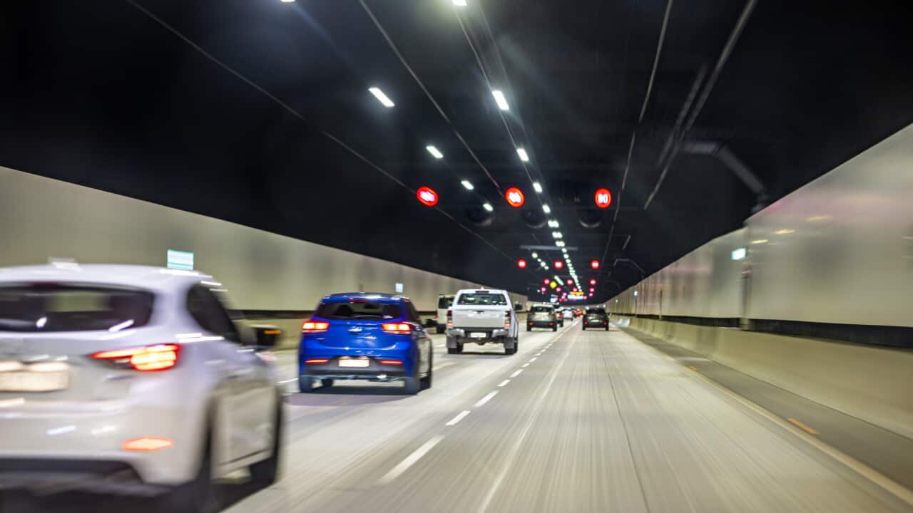 Cars driving in road tunnel, street lights highway