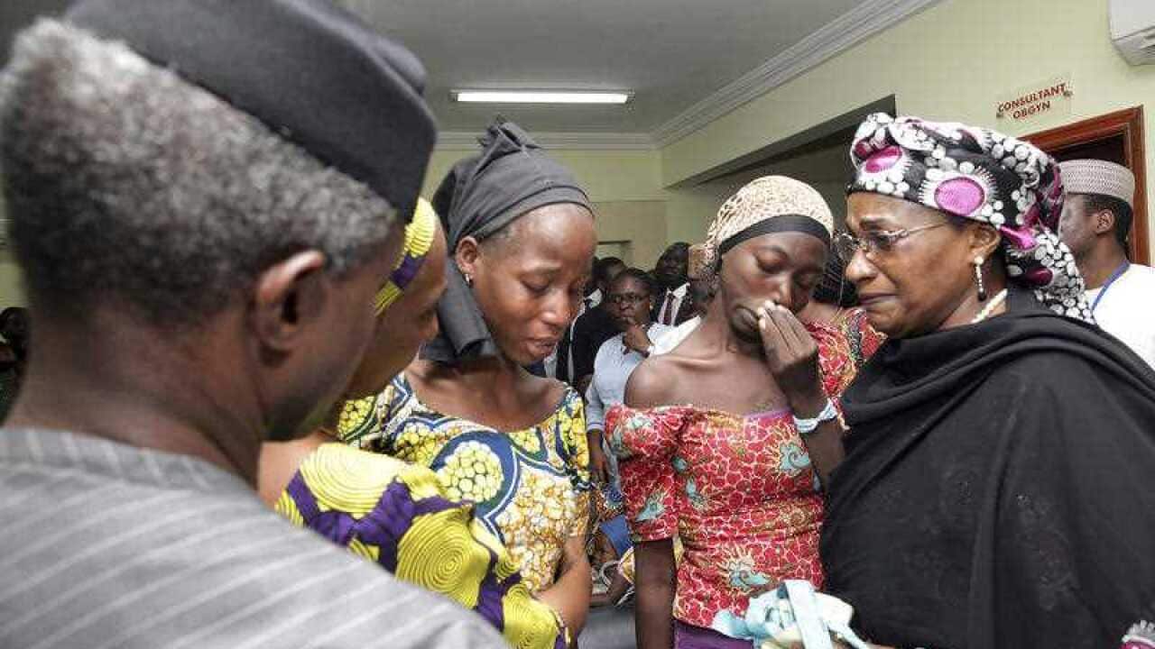 Nigeria's Vice President Yemi Osinbajo, left, welcomes some of the freed Chibok school girls at the state House in Abuja, Nigeria, Thursday, Oct. 13, 2016